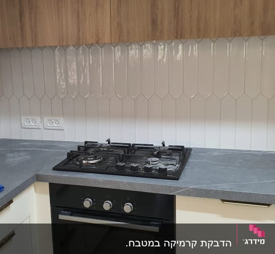 כיריים ותנור במטבח משופץ עם אריחים חדשים